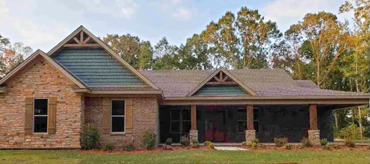 House plan exterior featuring a one-story design with a covered porch, gables, and a stone and brick facade. Decorative timber accents.