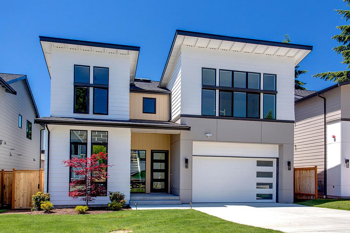 House plan exterior. Two-story modern house with flat rooflines, large windows, and a front-facing garage with glass panels.