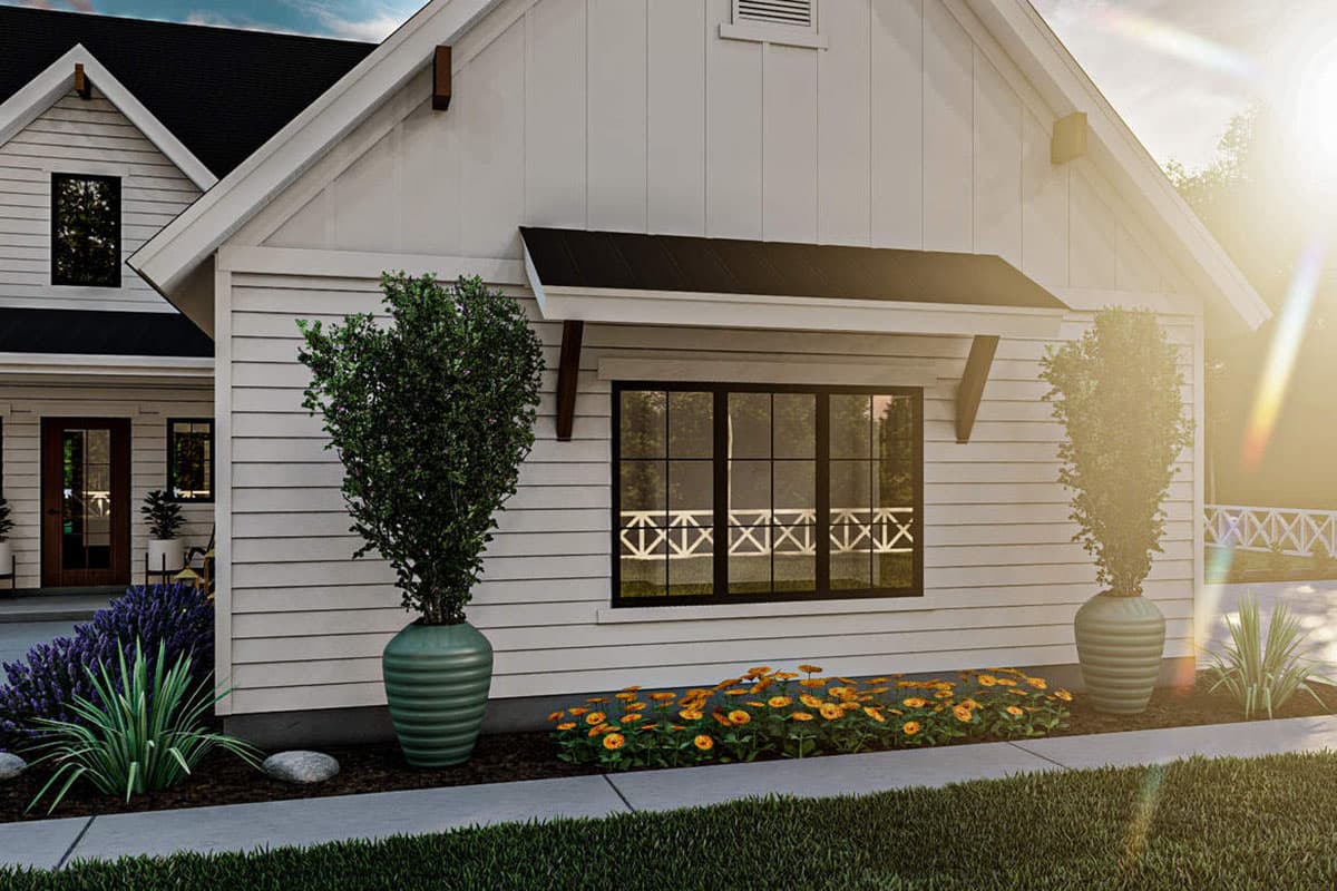 Modern Farmhouse house plan exterior with white horizontal siding, gables, and a large multi-pane window.