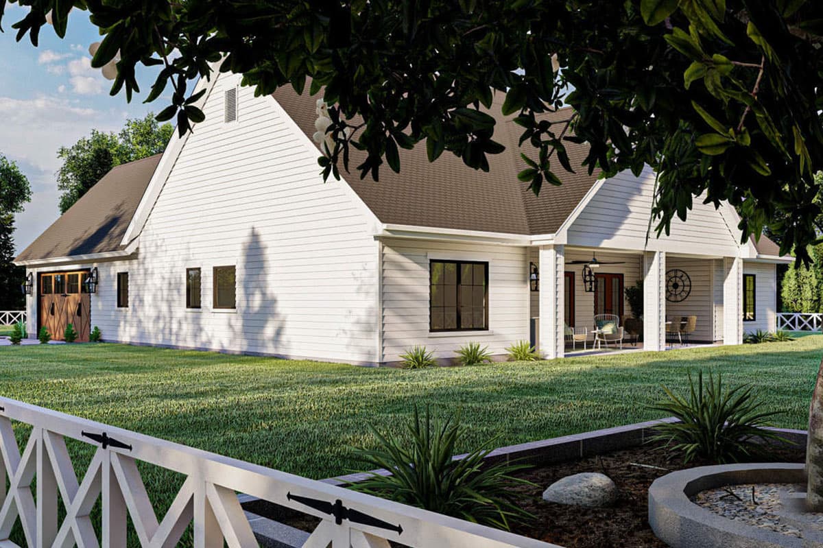 Modern Farmhouse house plan exterior with a wrap-around porch, white lap siding, and a detached garage with carriage doors.