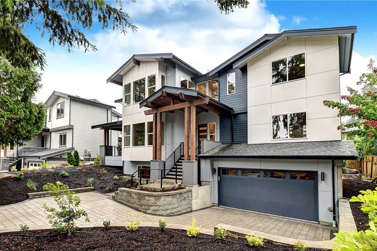 Modern house plan exterior with multi-story design, prominent wood-clad entry, and garage.