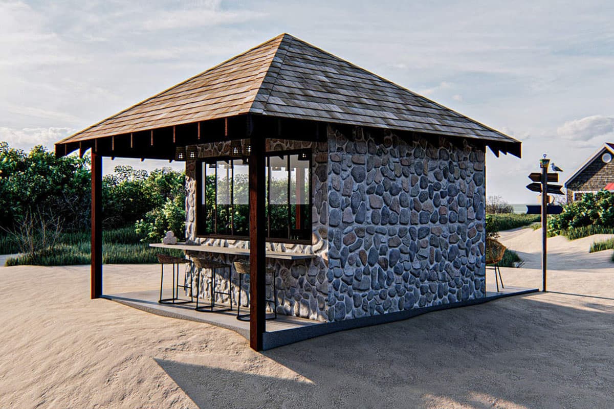 Exterior view of a small stone building with a shingled hip roof, an open bar counter, and large windows.