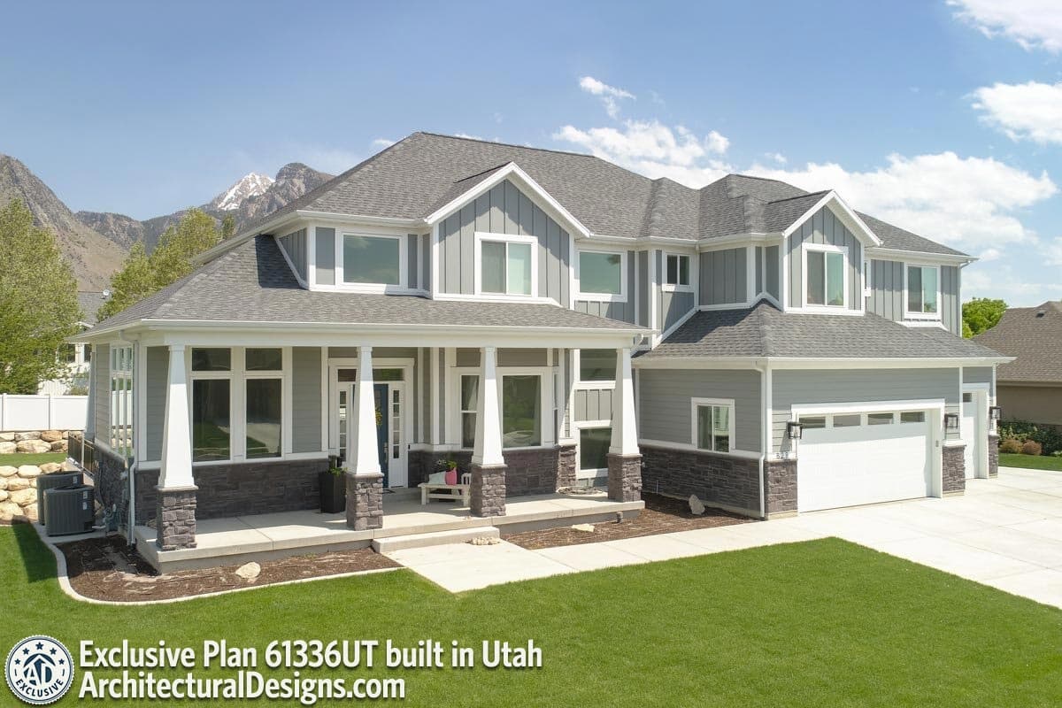 House plan exterior: two-story Modern Farmhouse with covered porch, stone accents, multiple gables, and side-facing garage.