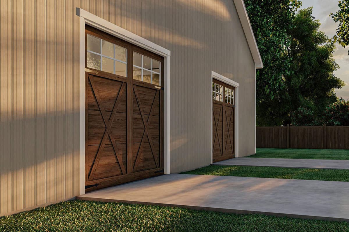 Exterior view of a house plan showing two wood paneled garage doors with windows above, set against a tan vertical siding exterior.
