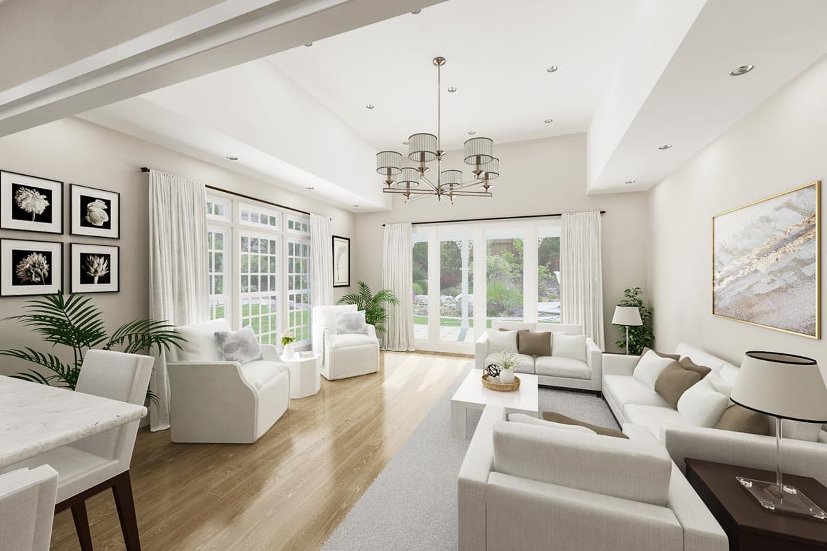 Living room with vaulted ceiling, large windows, fireplace, and open layout. Modern decor.