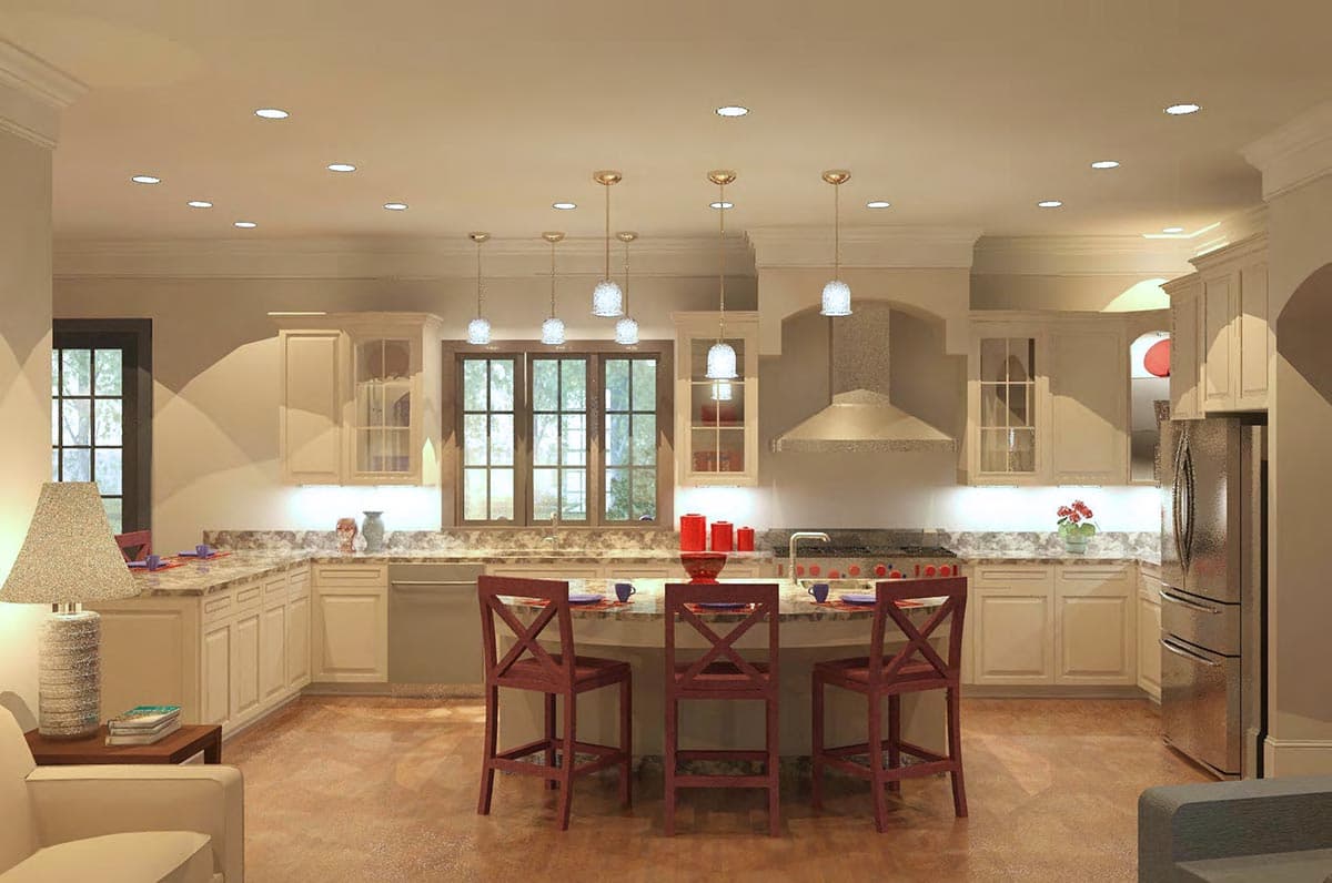 Kitchen with island seating, stainless steel appliances, range hood, and ample cabinet space.
