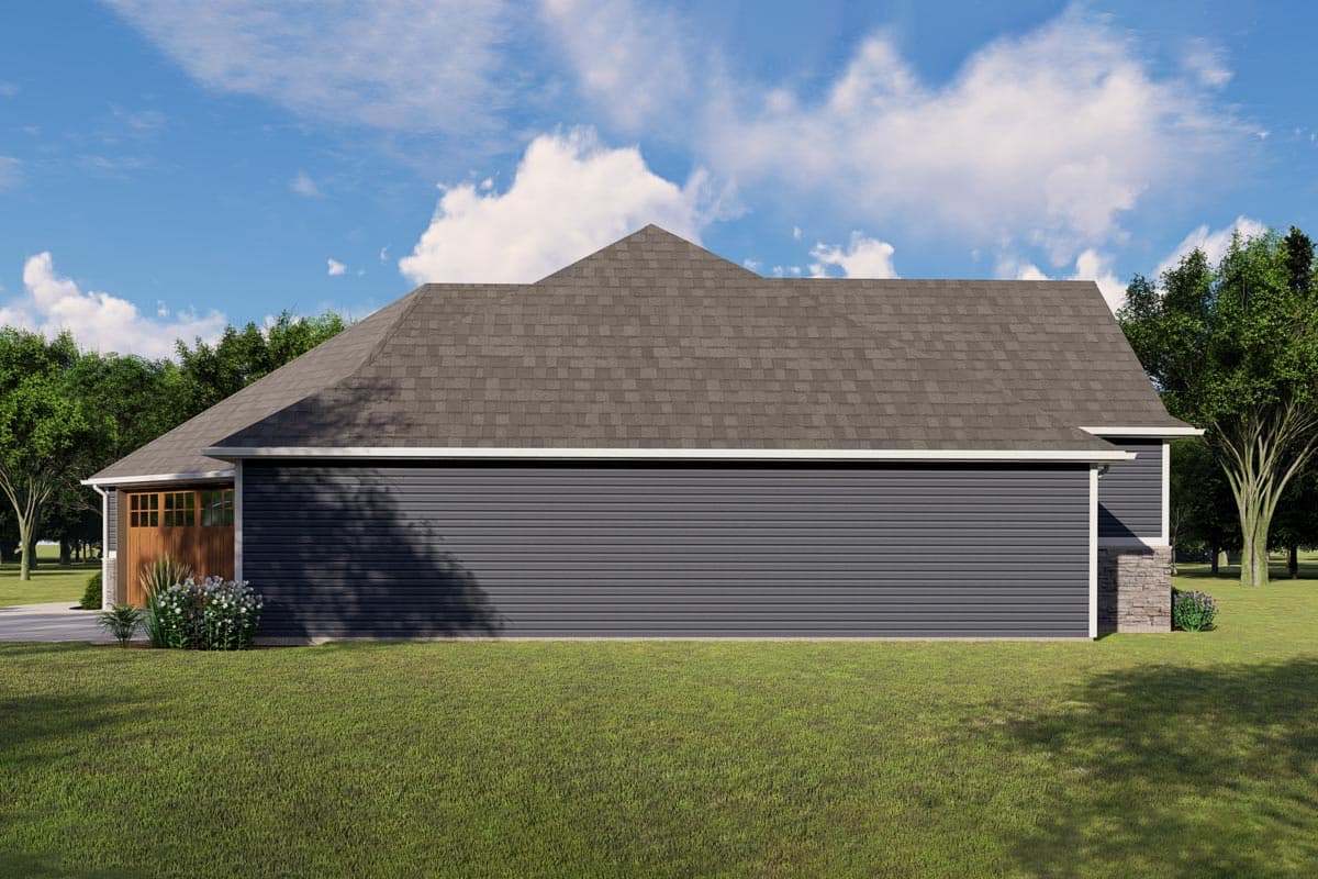 House plan exterior: Side view of a single-story home with a gable roof, dark siding, stone accents, and a wood-paneled garage door.