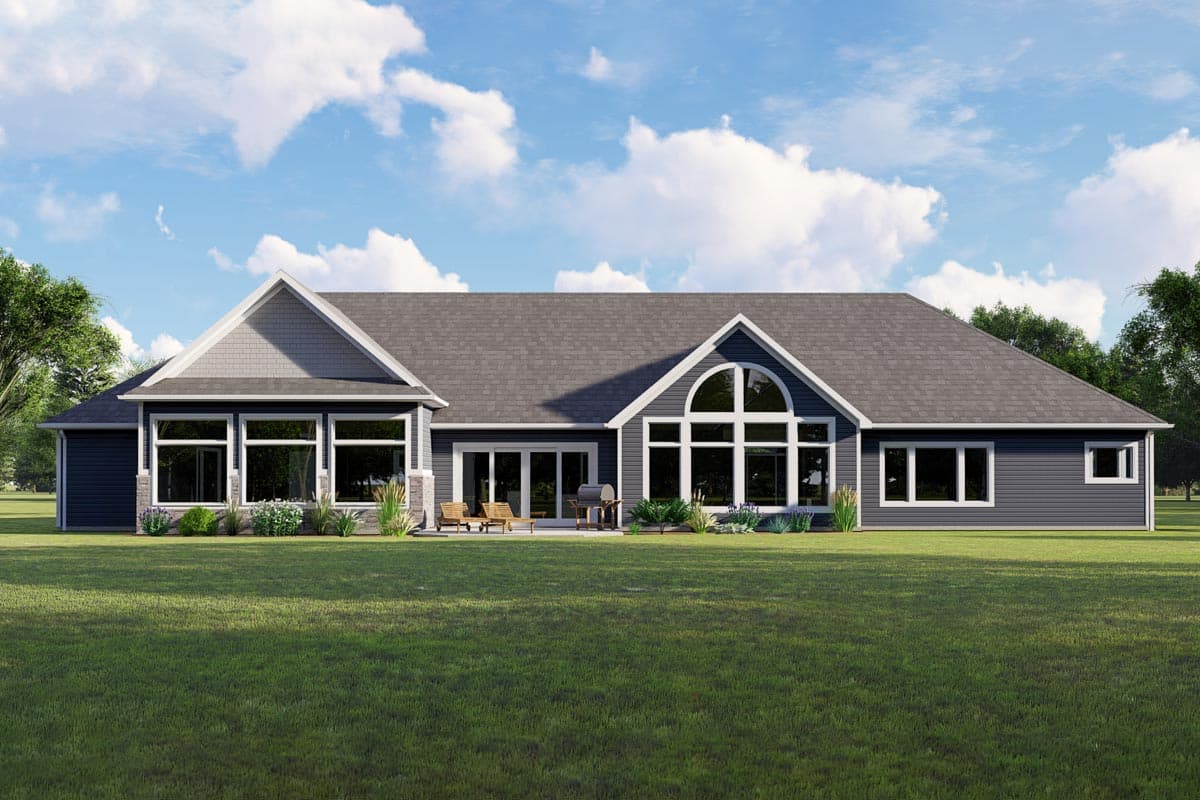 Modern ranch house plan exterior with multiple gables, a large arched window, and extensive fenestration.