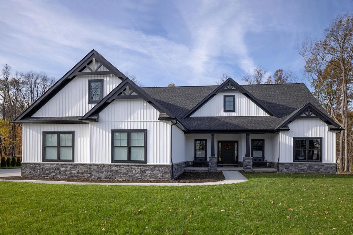 House plan exterior. Modern Farmhouse style with board-and-batten siding, multiple gables, and a covered front porch with dark trim.