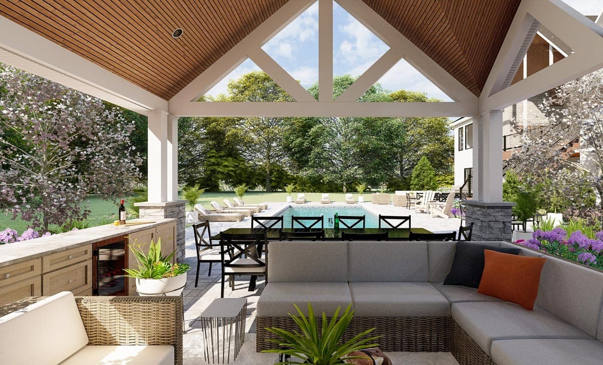 Outdoor living space featuring a covered patio with wood ceiling, seating area, dining table, and pool.