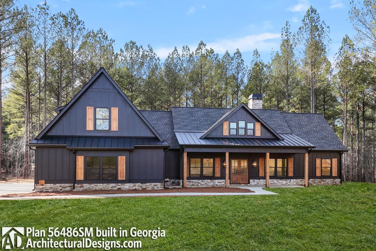 Modern Farmhouse house plan exterior with dark vertical siding, gabled dormers, stone base, and a covered front porch.
