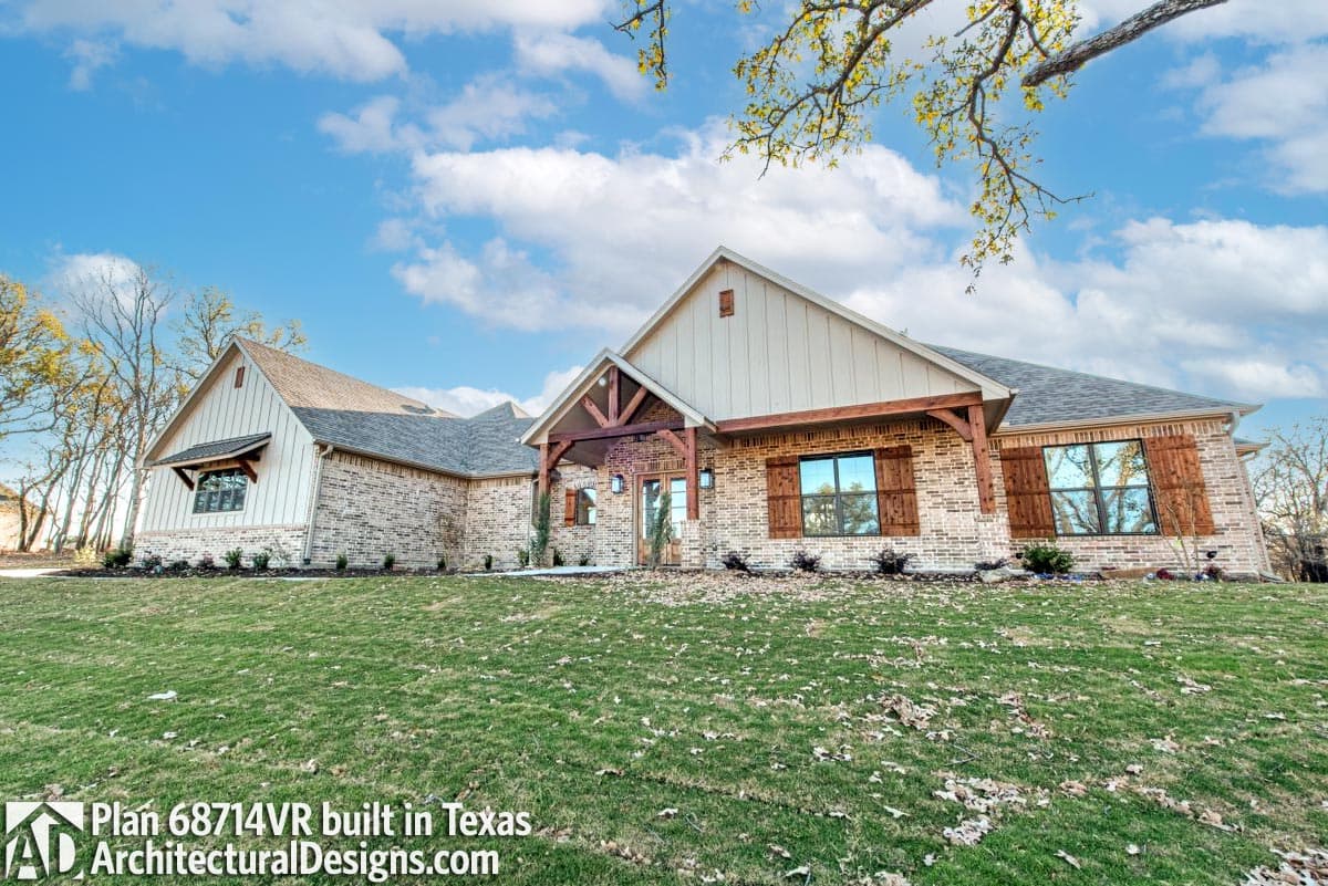 House plan exterior: Single-story Modern Farmhouse with brick exterior, exposed wood beams, gabled roof, and large wood shutters.