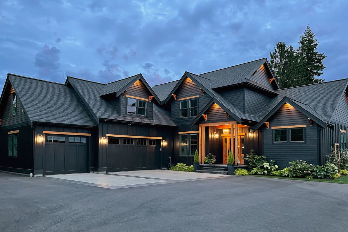 House plan exterior. Two-story, Modern Farmhouse style with gabled roof, board-and-batten siding, and a front porch with timber frame detailing.