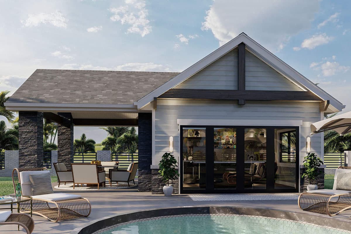 House plan exterior with gable roof, stone-clad columns, and covered patio. Features include large sliding glass doors and pool.