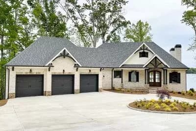 New American House Plan for a Rear Sloping Lot with Angled 3-car Garage Plus a Drive-under Garage