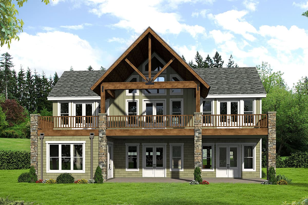 House plan exterior: two-story lodge-style home with large gable, exposed beams, wraparound deck, and stone accents.