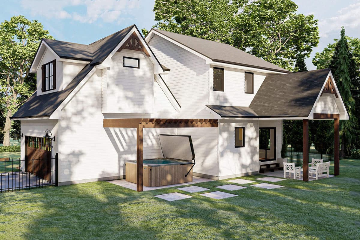 House plan exterior with gables, dormers, and a two-car garage. Features a covered patio with a hot tub.