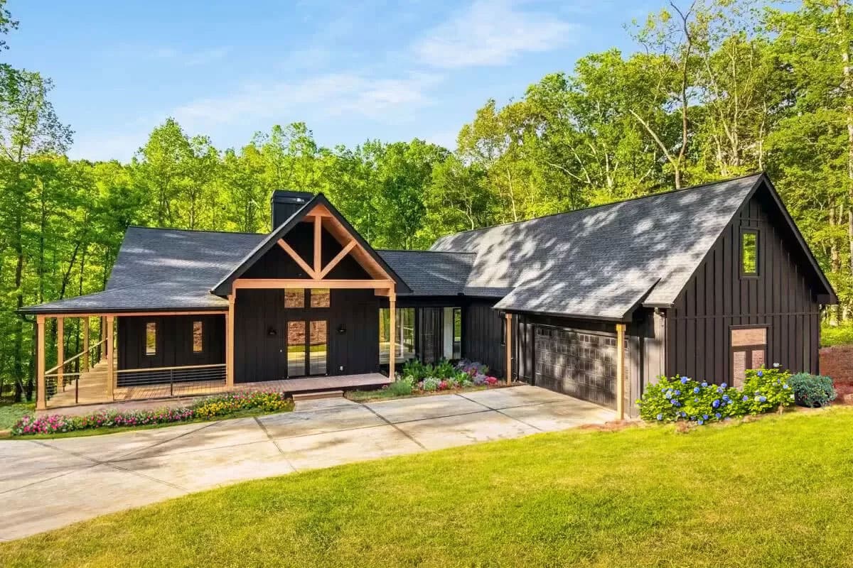 House plan exterior. Modern Farmhouse-style, one-story home with a gabled roof, timber frame detail, and attached garage with a concrete driveway.