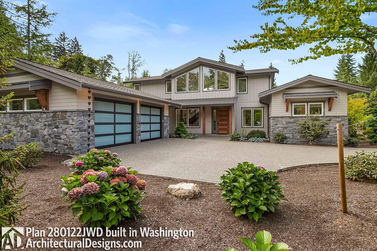 Modern house plan exterior with three-car garage, stone accents, and large windows. Two stories.
