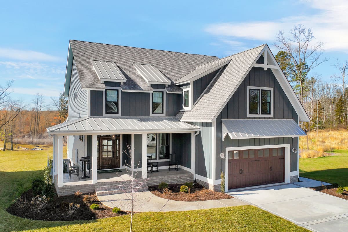 House plan exterior featuring Modern Farmhouse style, two stories, covered porch, multiple gables, and attached garage.