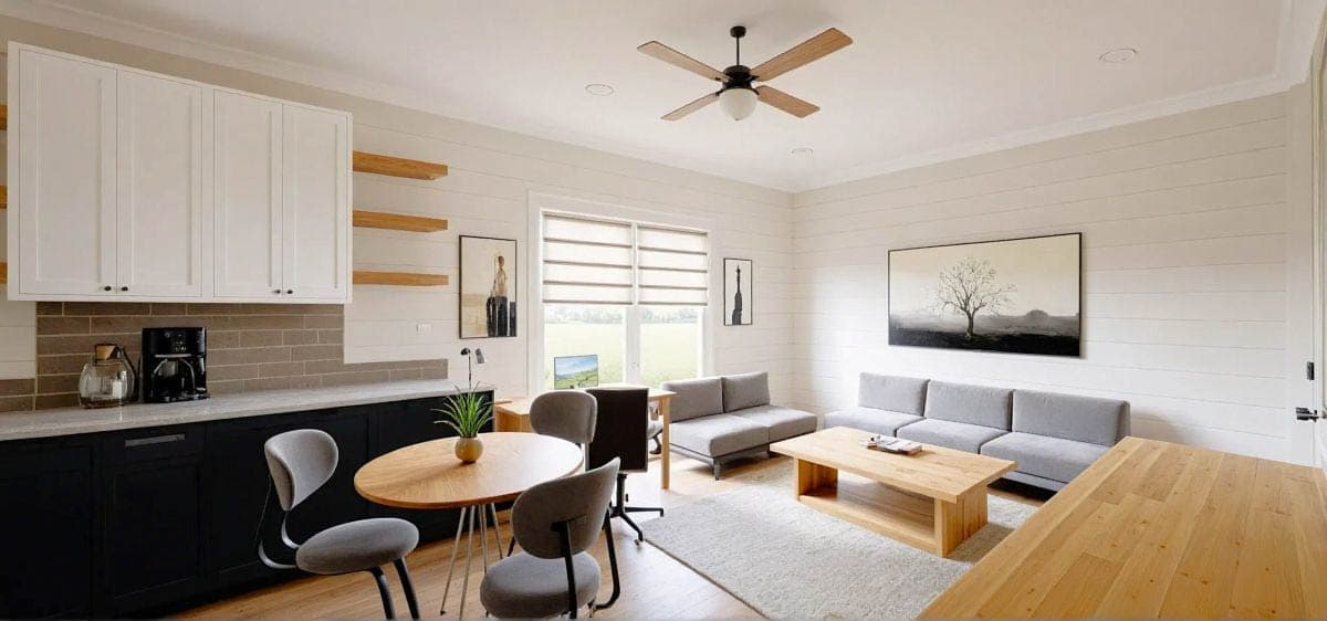 Living area with coffee station, dining table, sectional sofa, coffee table, and shiplap walls.