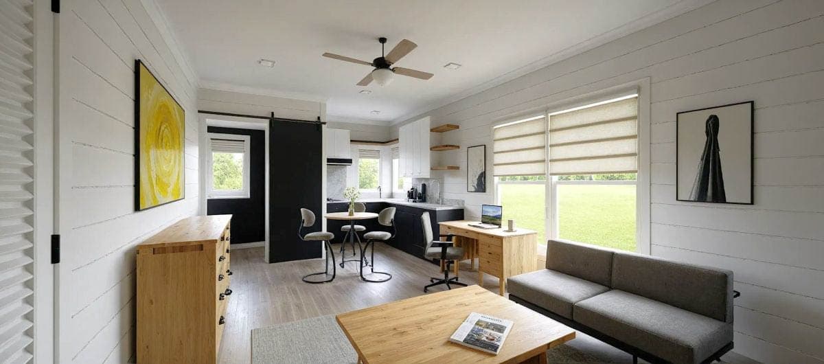 Open concept living area with kitchen, dining nook, workspace, and seating.