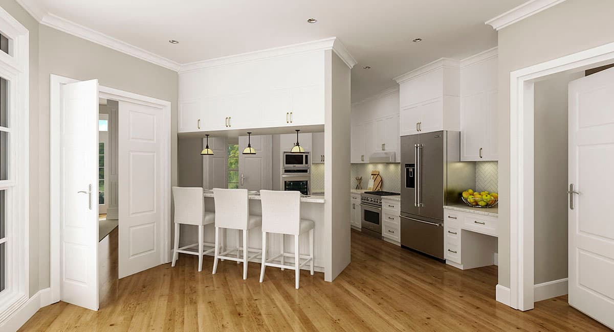 Kitchen interior with island seating, stainless steel appliances, and white cabinetry.