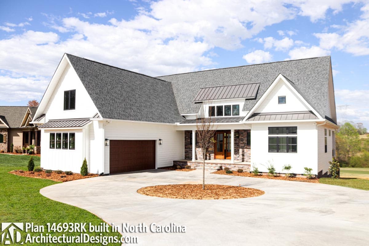 House plan exterior featuring a Modern Farmhouse style with a prominent gable, metal roof accents, and a two-car garage.