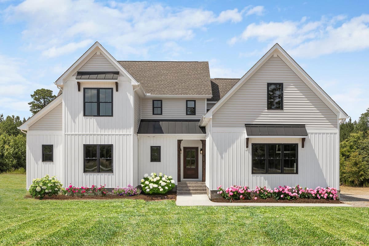 House plan exterior featuring Modern Farmhouse style with two stories, gables, black window frames, and covered porch.
