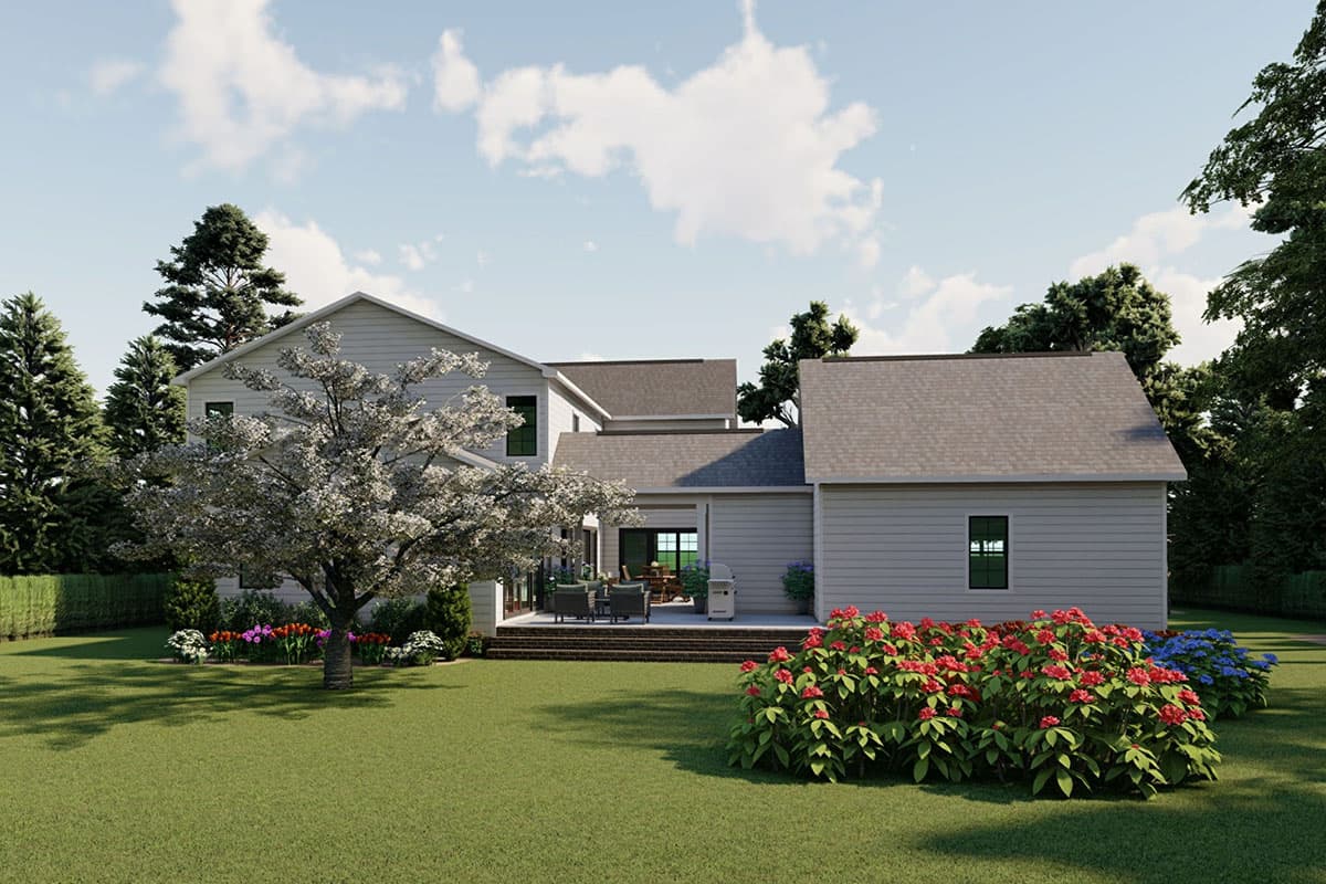 House plan exterior: Two-story home with gabled rooflines, large rear patio with seating, and mature landscaping.