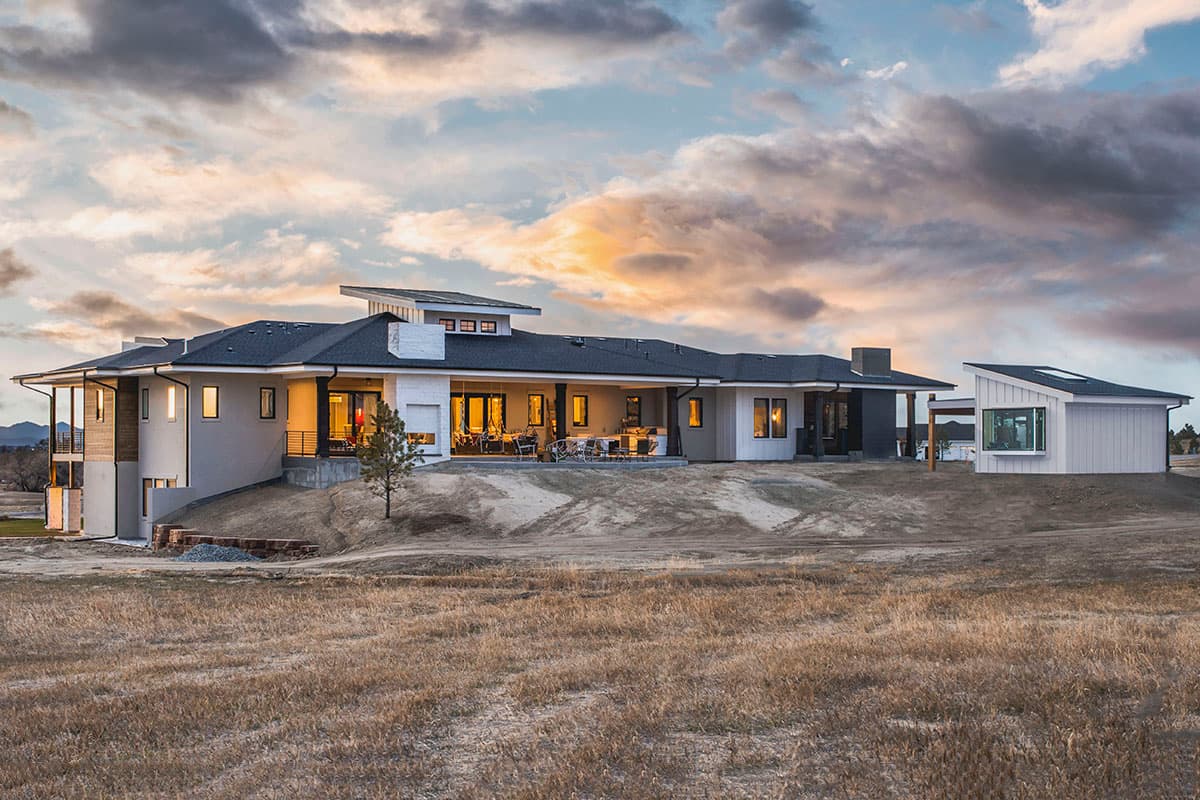 Modern house plan exterior: one story, flat rooflines, solar panels, covered patio, and detached garage.