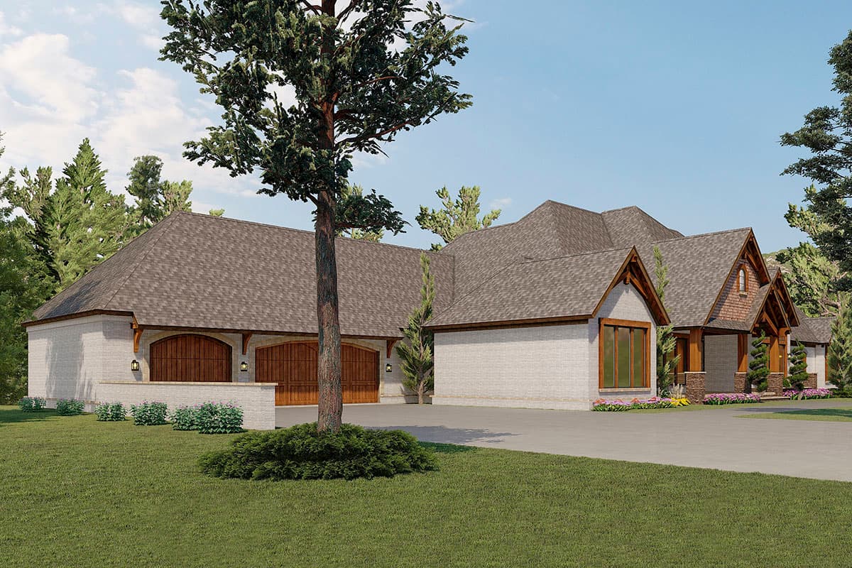 House plan exterior with a three-car garage featuring arched wooden doors, brick exterior, and prominent gables.