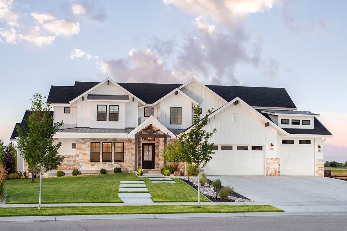 House plan exterior featuring Modern Farmhouse style with two stories, gabled rooflines, stone accents, and a front-entry porch.