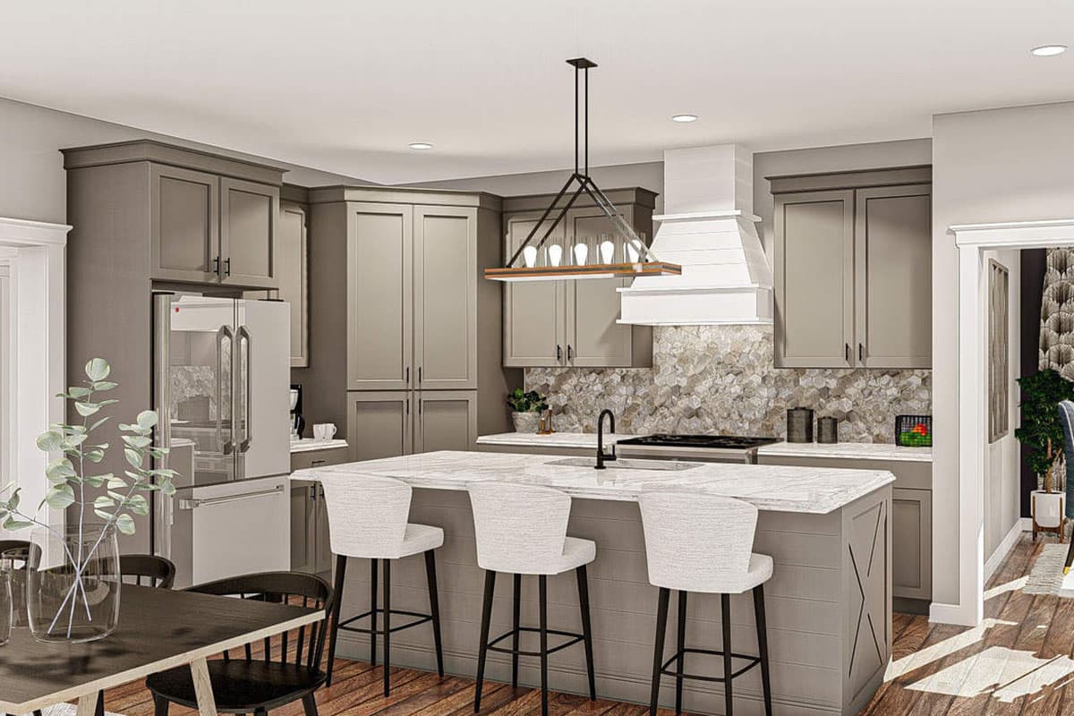 Kitchen with gray cabinetry, a large island with seating, stainless steel appliances, and a decorative backsplash.