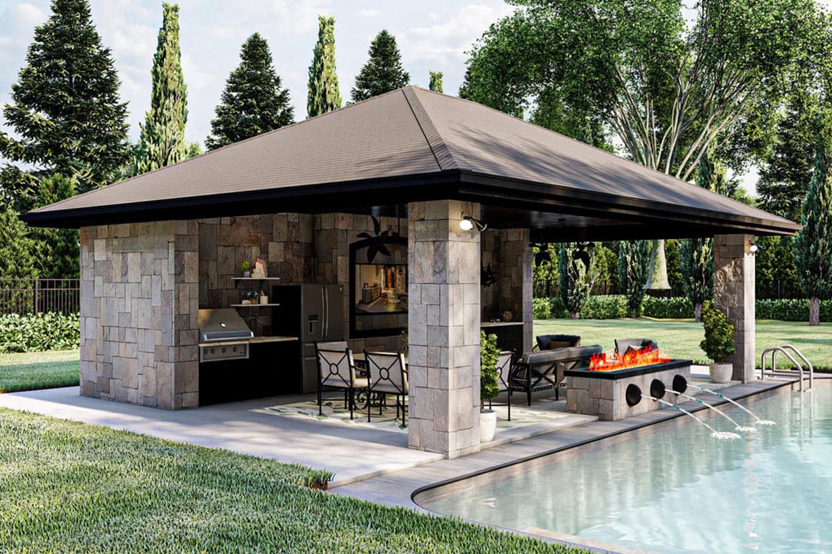 Outdoor kitchen and lounge area with stone facade, built-in grill, fire pit, seating, and pool.