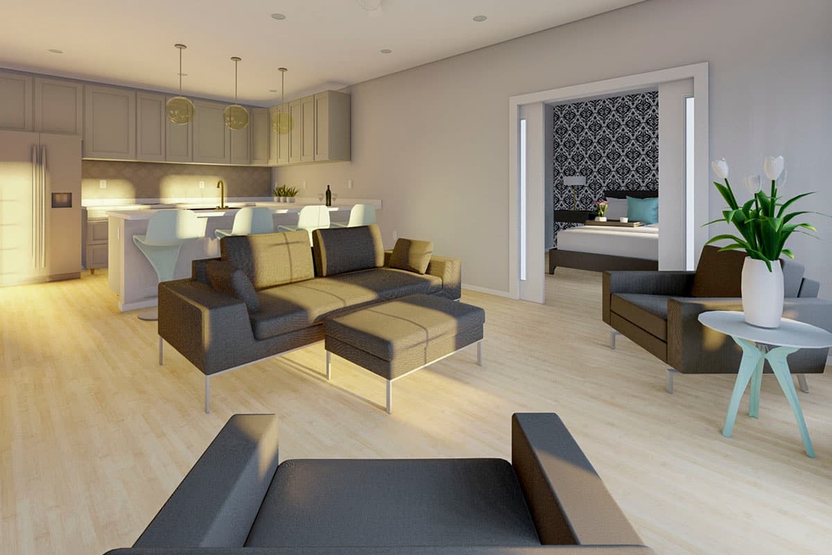 Open concept living space with kitchen island, seating area, and view into a bedroom with patterned wallpaper.