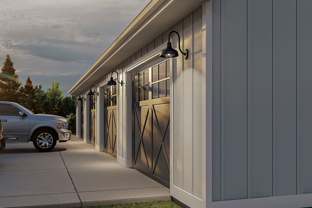 House plan exterior: Garage with three doors, paneled design, and gooseneck barn lights.
