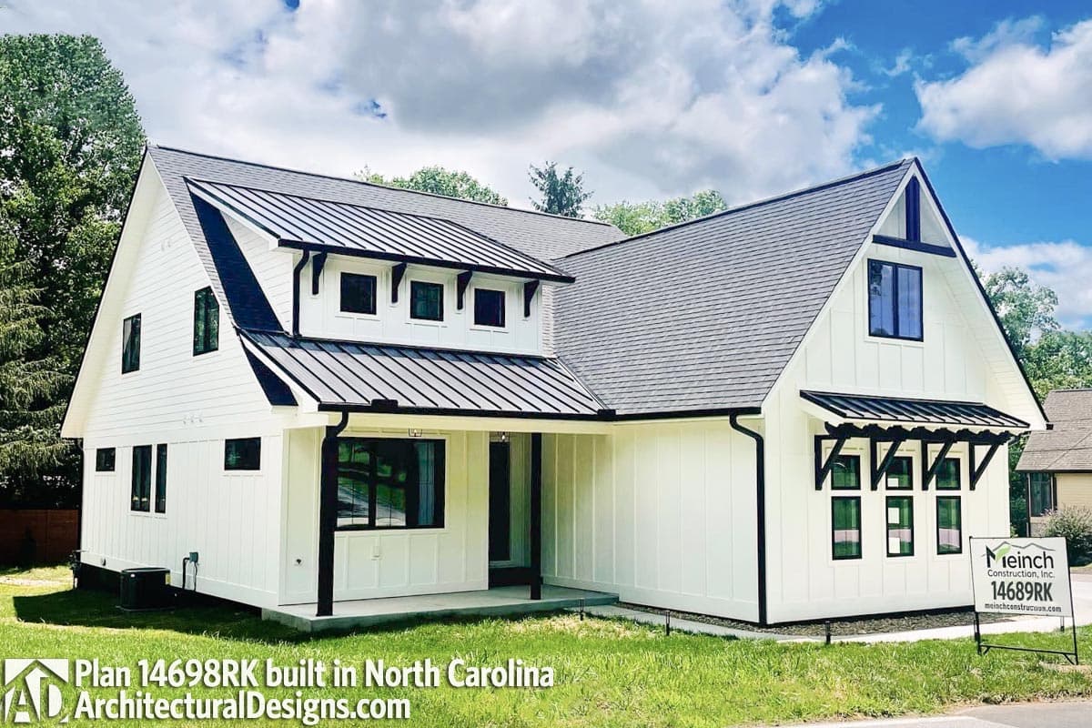 House plan exterior: Modern Farmhouse style with gables, dormers, black metal roof, and covered porch.