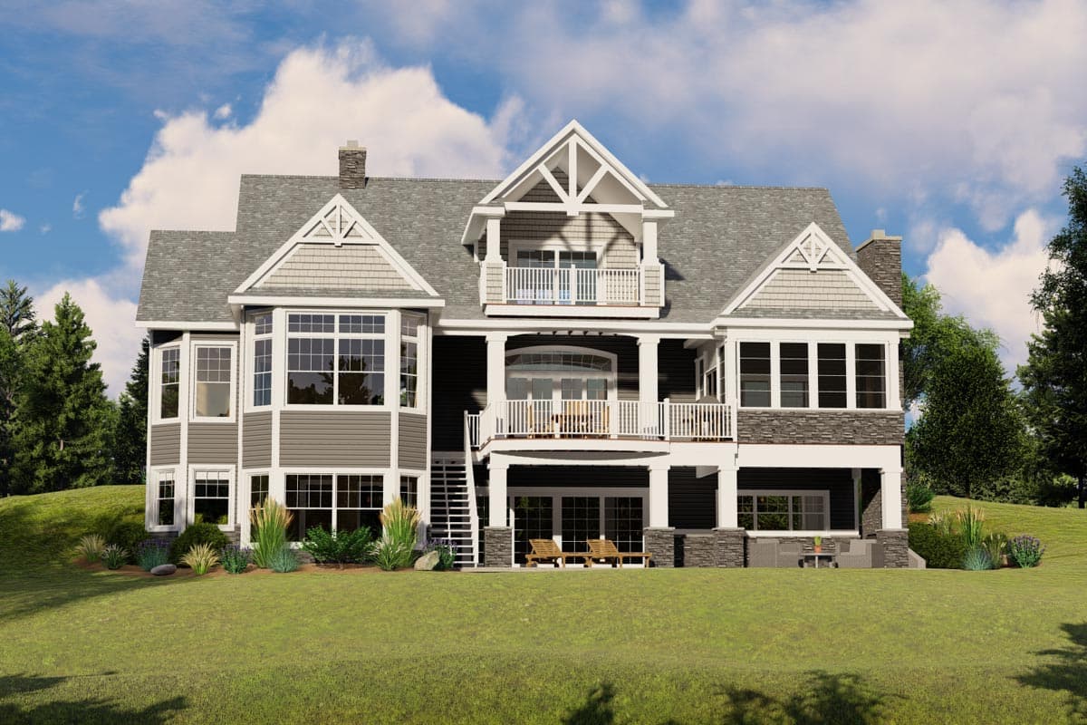 House plan exterior: two-story dwelling with bay windows, gables, stone accents, and covered upper and lower balconies.
