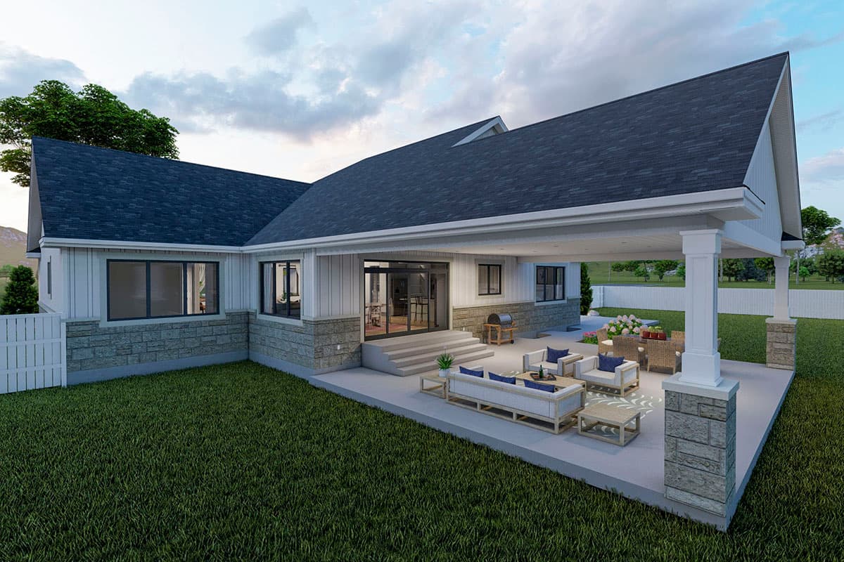 House plan exterior: Ranch style, covered patio with seating, stone and vertical siding, large windows, gabled roof.