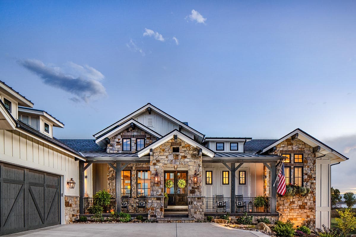 Modern Farmhouse house plan exterior with stone accents, gable dormers, covered porches, and attached garage.