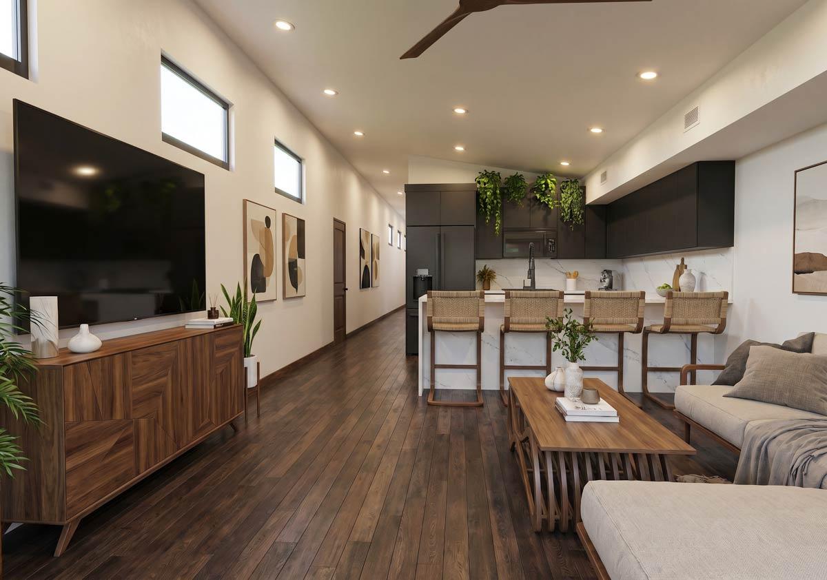 Modern living area and kitchen with dark cabinetry, island with bar stools, and wood flooring.