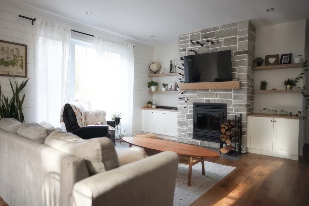Living room featuring a stone fireplace with TV, built-in cabinetry, wood flooring, and neutral-toned furniture.