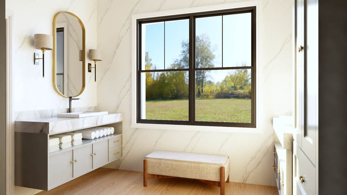 Bathroom with floating vanity, marble countertop, oval mirror, and large window overlooking a field.