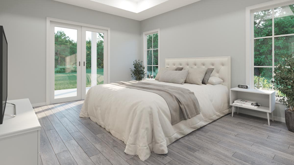 Bedroom with tufted headboard, sliding glass doors, and grid-pane windows.