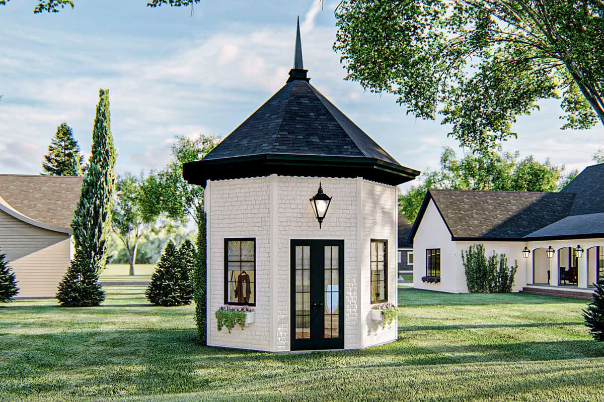 House plan exterior featuring a multi-sided structure with a black roof and a lantern. The exterior has windows, a door, and flower boxes.