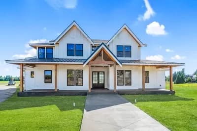 Farmhouse with a Board and Batten Splash, a 2-Story Living Room and a Unique Angled Garage