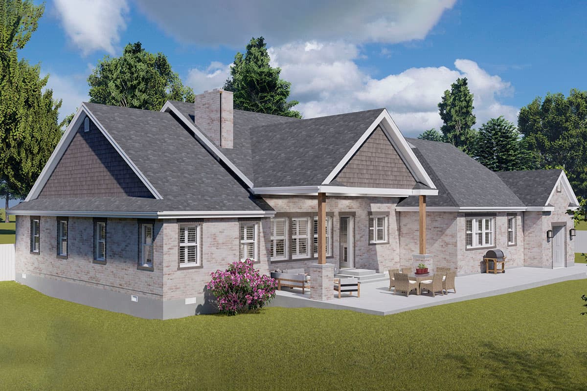 House plan exterior: One-story brick home with gable roof, prominent chimney, and covered porch with wooden columns.