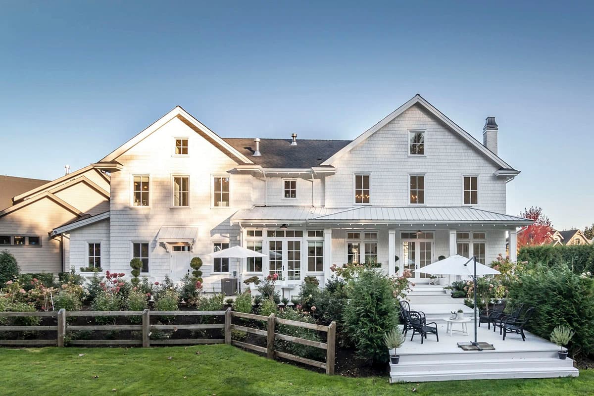 Modern Farmhouse house plan exterior with gables, dormers, covered porch, and multi-level deck.