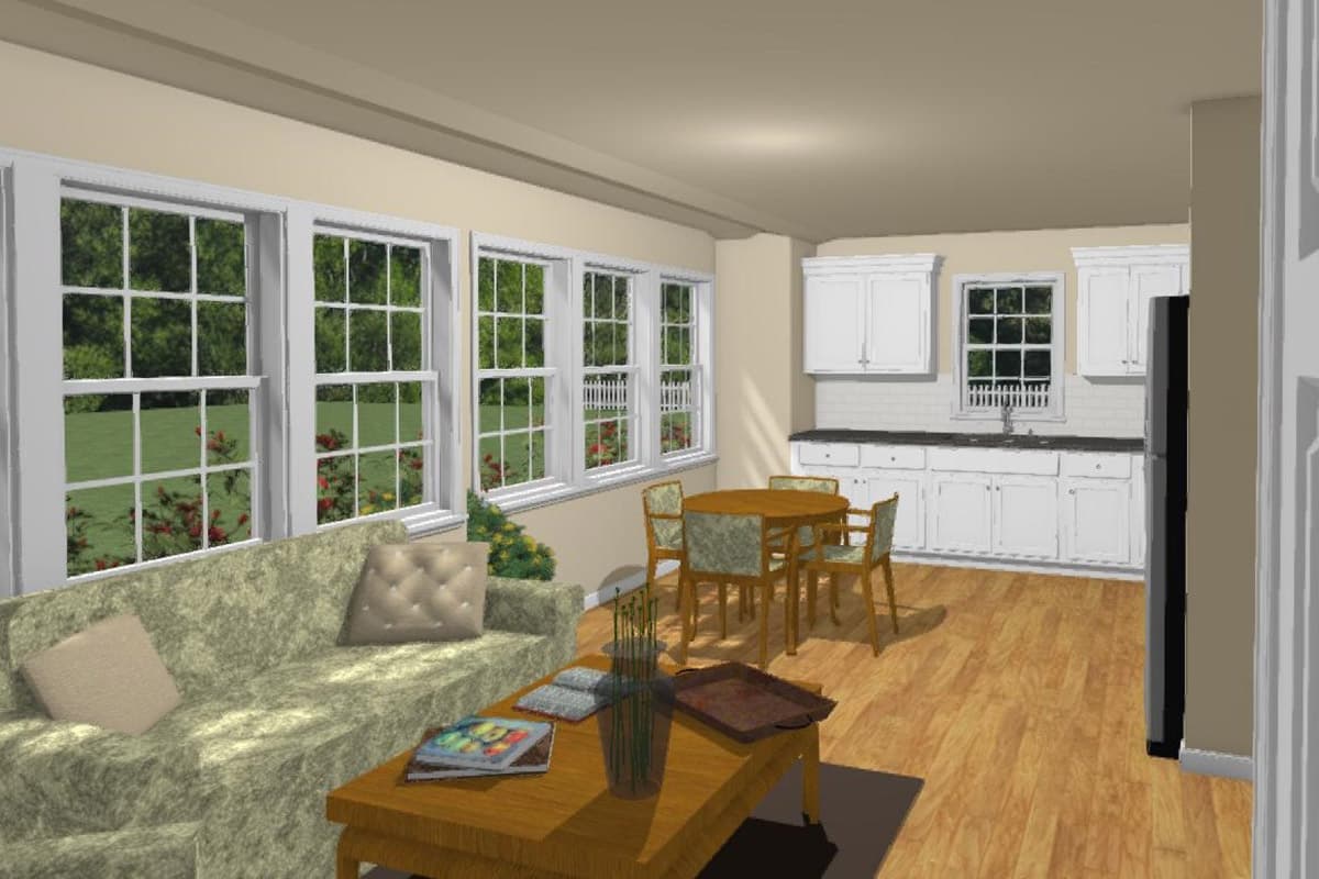 Living area with sofa, coffee table, and dining set adjacent to kitchen with white cabinetry and subway tile backsplash.